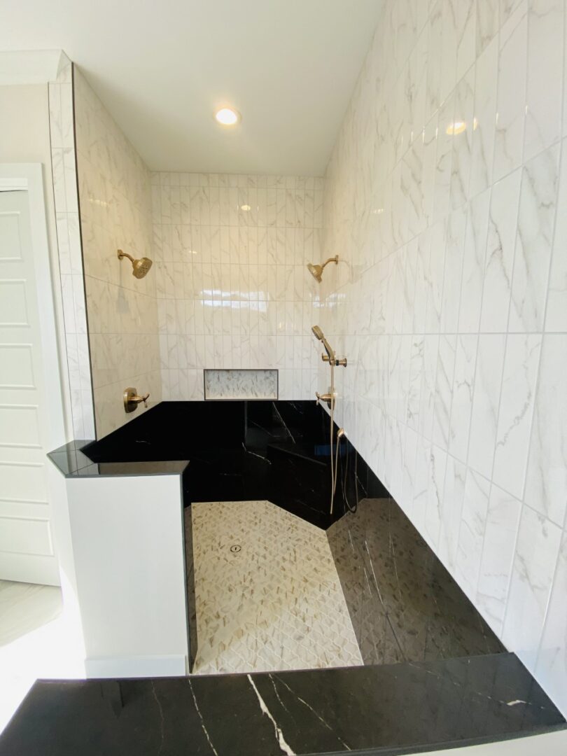 black and white tiles bathroom with showers