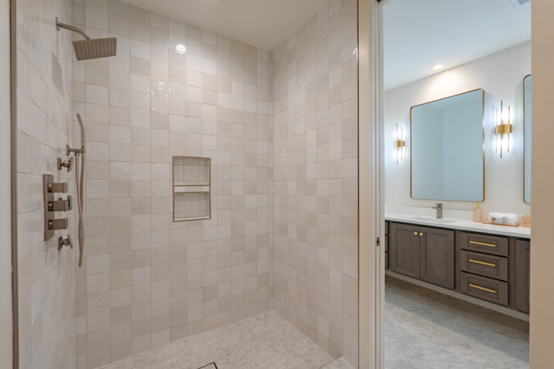 Shared bathroom with custom tiled shower and body jets.