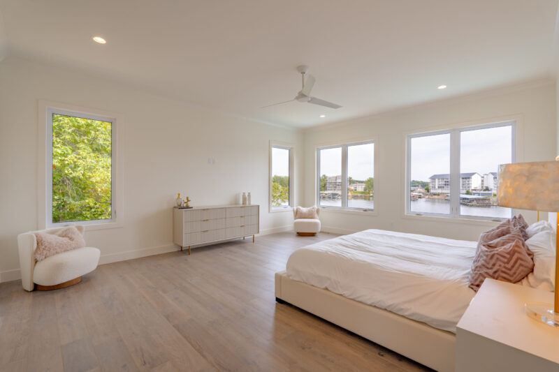 Primary Suite with clean modern finishes and a beautiful view of the lake.