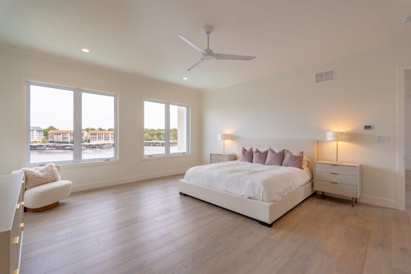 Primary Suite with clean modern finishes and a beautiful view of the lake.