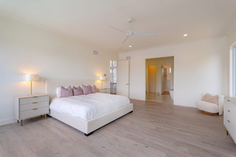 Primary Suite with clean modern finishes and a beautiful view of the lake.