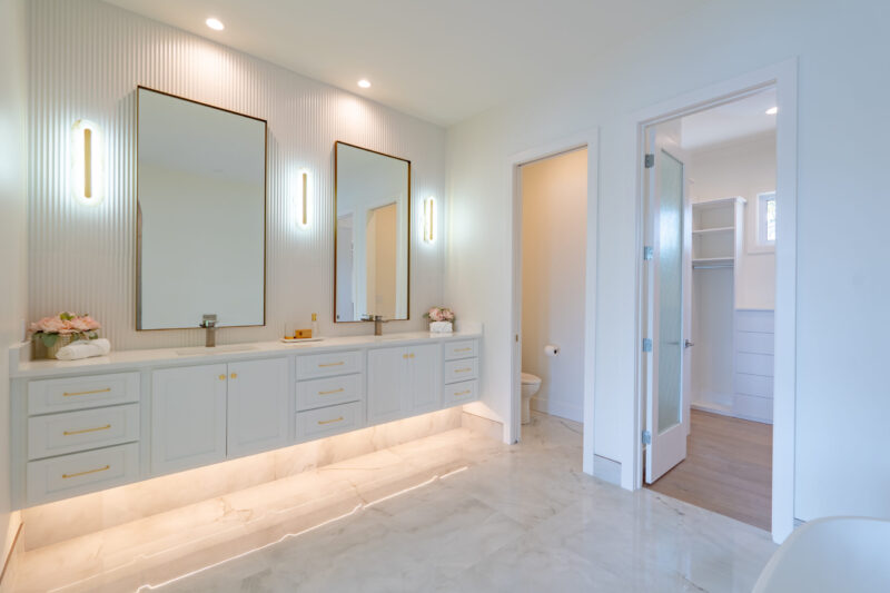 Luxury primary suite with floating modern vanity and double sinks. The fluted backsplash looks perfect with the 10 ft walls.