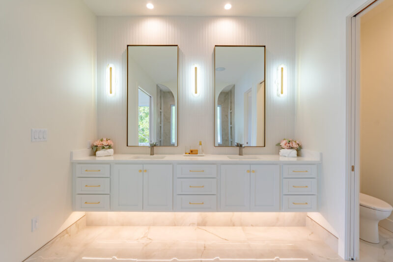 Luxury primary suite with floating modern vanity and double sinks. The fluted backsplash looks perfect with the 10 ft walls.