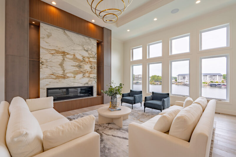 Modern Lake View Great Room with luxurious book matched stone fireplace.