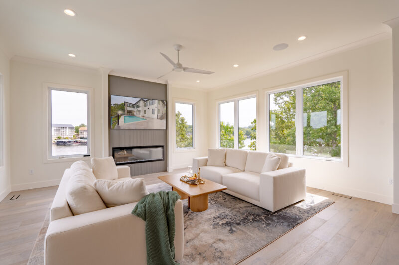 The sunroom features a tiled fireplace and an electric unit, providing a 180-degree view of the lake.