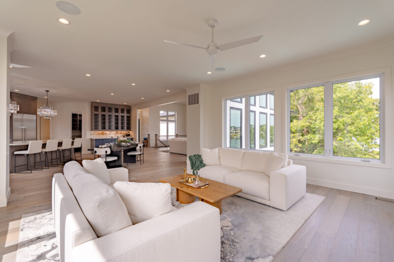 The sunroom features a tiled fireplace and an electric unit, providing a 180-degree view of the lake.