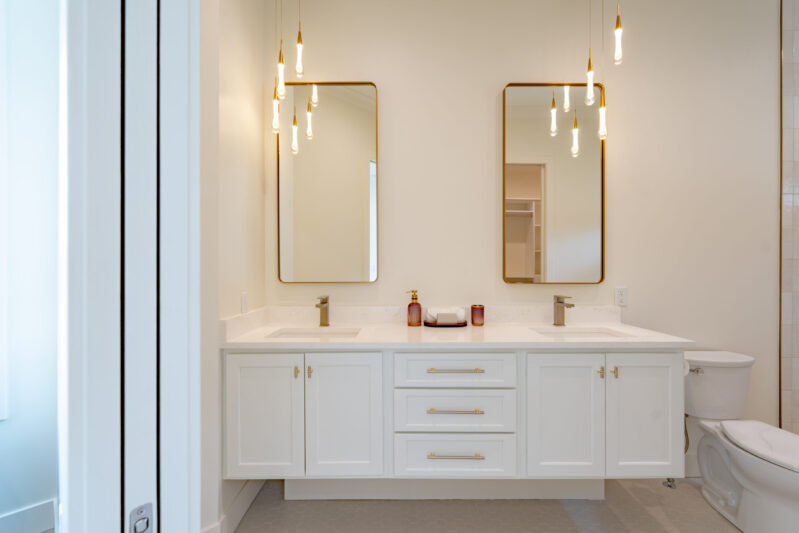 Suite number two features a modern floating vanity, double sinks and elegant modern lighting.