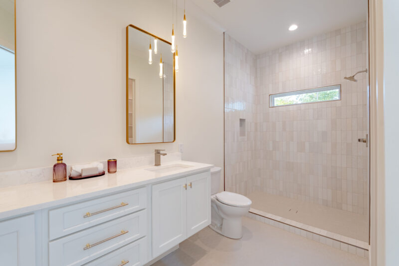 Suite number two features a modern floating vanity, double sinks and elegant modern lighting.