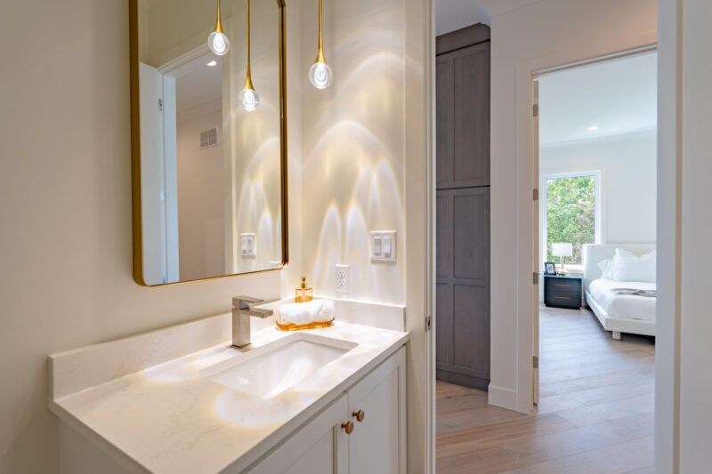 Half bath on the main level with modern lighting and floating vanity.