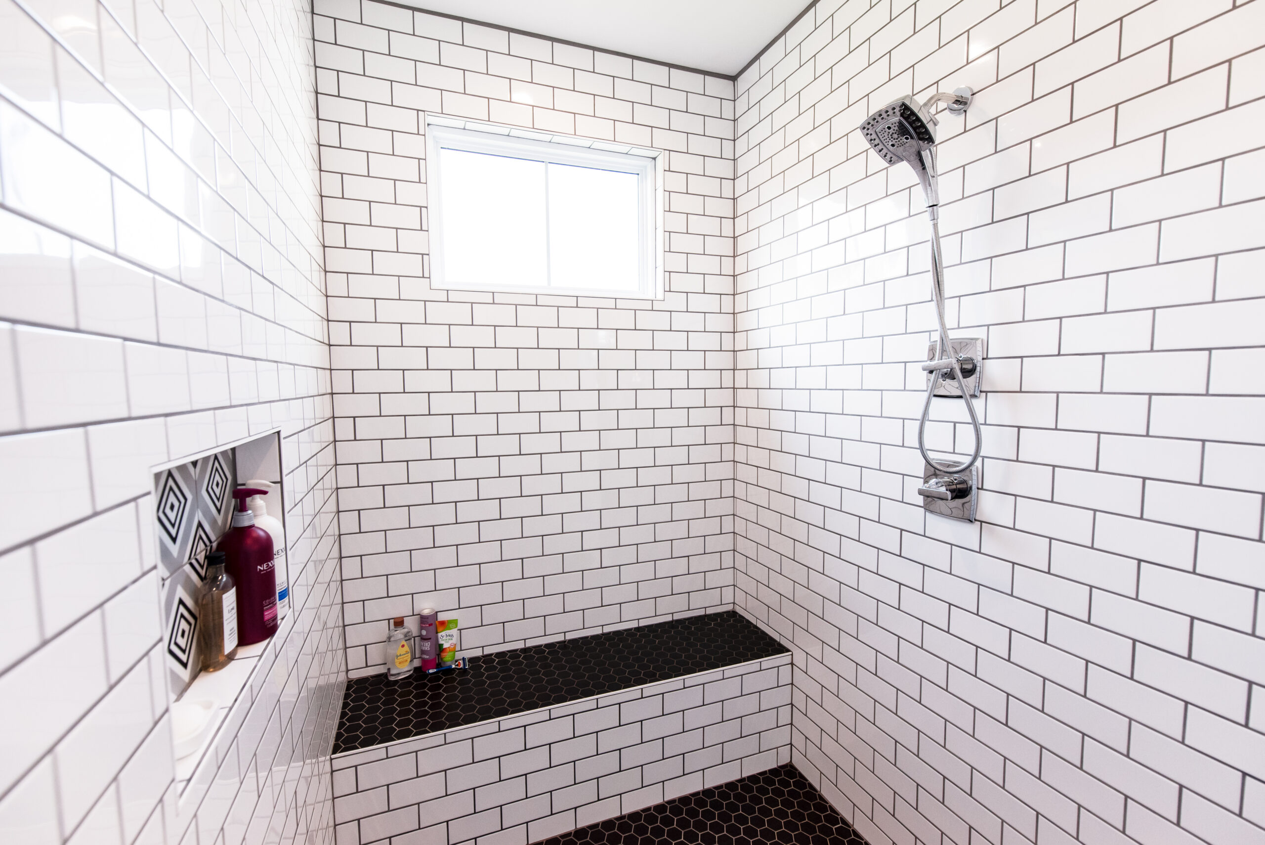 For a primary walk-in shower, subway tile is a classic choice.