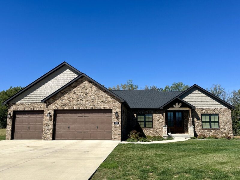 Custom built Legacy home with dark exteriors and 3 car garage.