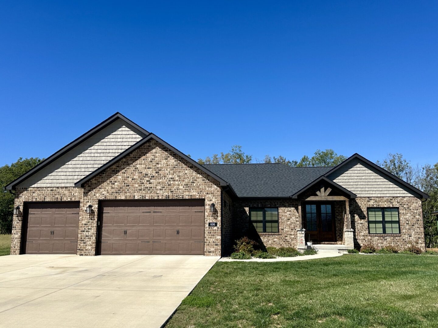 Custom built Legacy home with dark exteriors and 3 car garage.